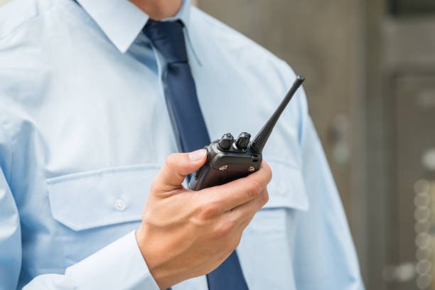 Close-up Photo Of Security Guard Holding Walkie-talkie